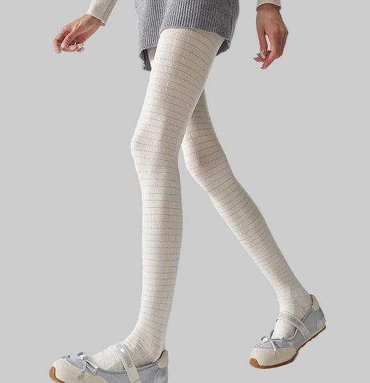 Women's 3D plaid textured tights in white, worn with silver ballet flats
