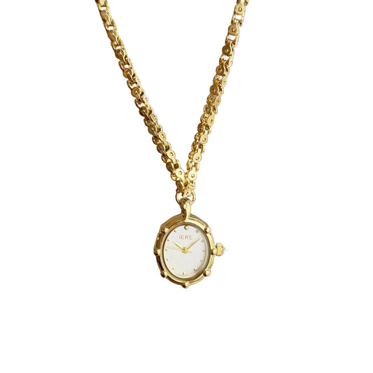 Gold oval pendant watch with a white dial on a chunky chain
