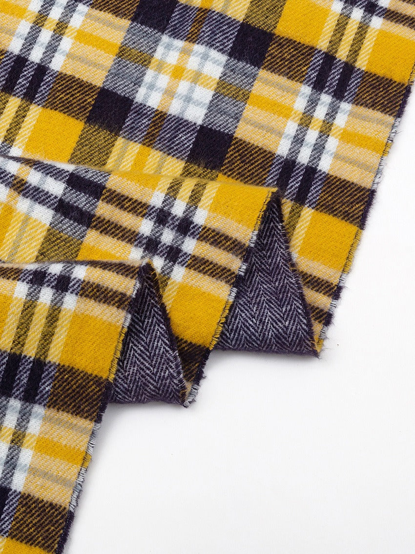 Close-up of the yellow plaid scarf folded to show the navy reverse side