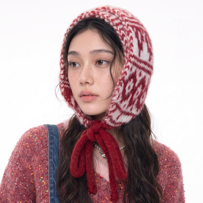 Woman wearing the red and white Fair Isle knitted hood with long red ties