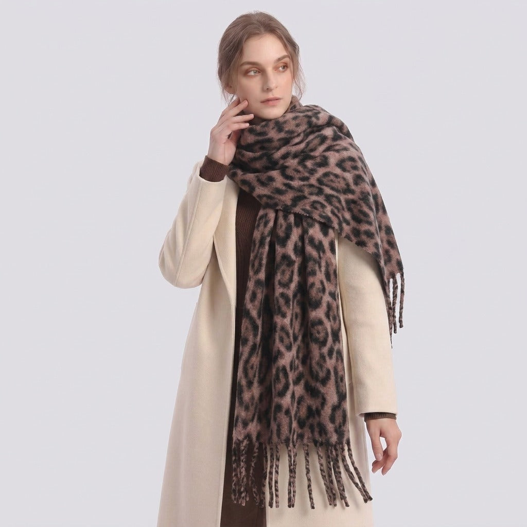 Woman in a cream coat wearing the leopard-print fringe scarf