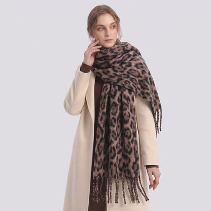 Woman in a cream coat wearing the leopard-print fringe scarf