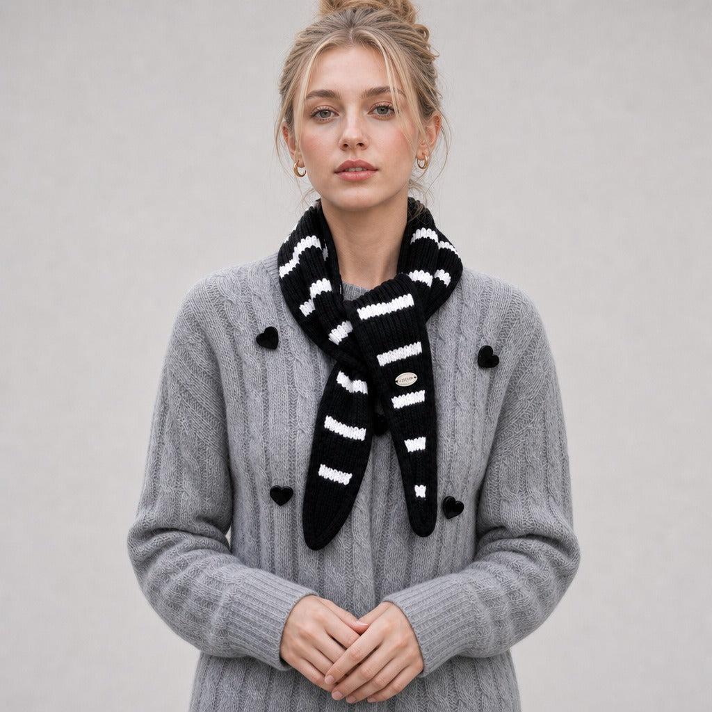 Front view of the black striped triangle scarf knotted at the neck