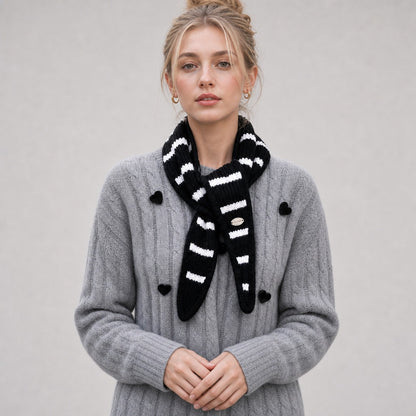 Front view of the black striped triangle scarf knotted at the neck