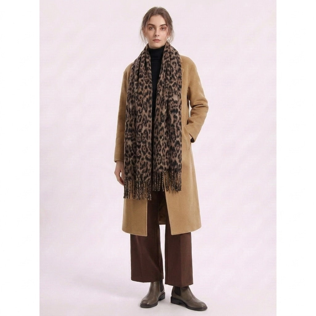 Full-length view of a woman wearing the leopard-print scarf with a camel coat