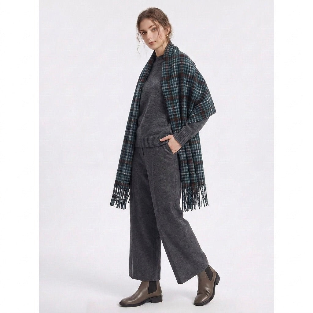 Full-length view of a woman wearing the green houndstooth fringe scarf