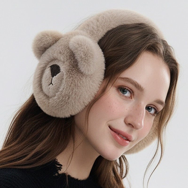 Woman wearing the khaki bear earmuffs, smiling