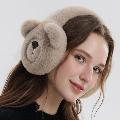 Woman wearing the khaki bear earmuffs, smiling