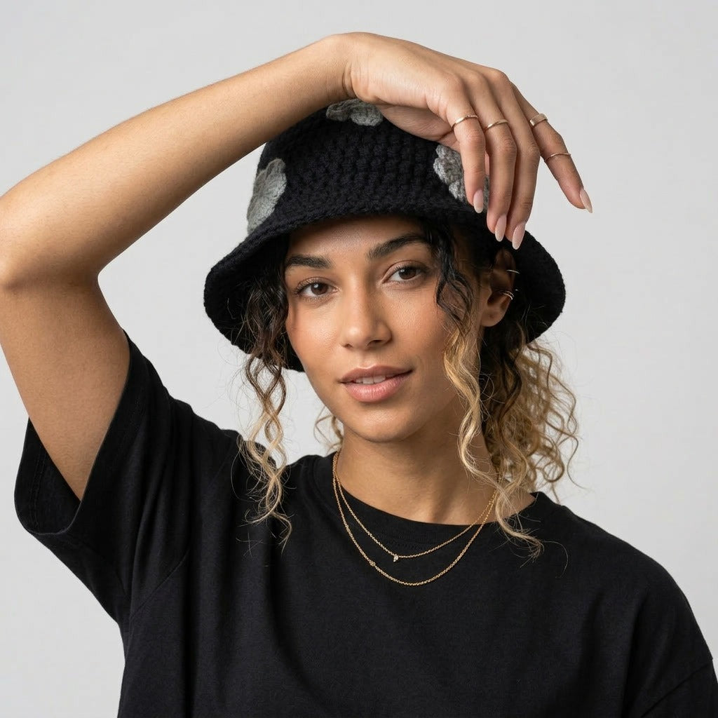 Woman with her arm raised wearing the black floral bucket hat