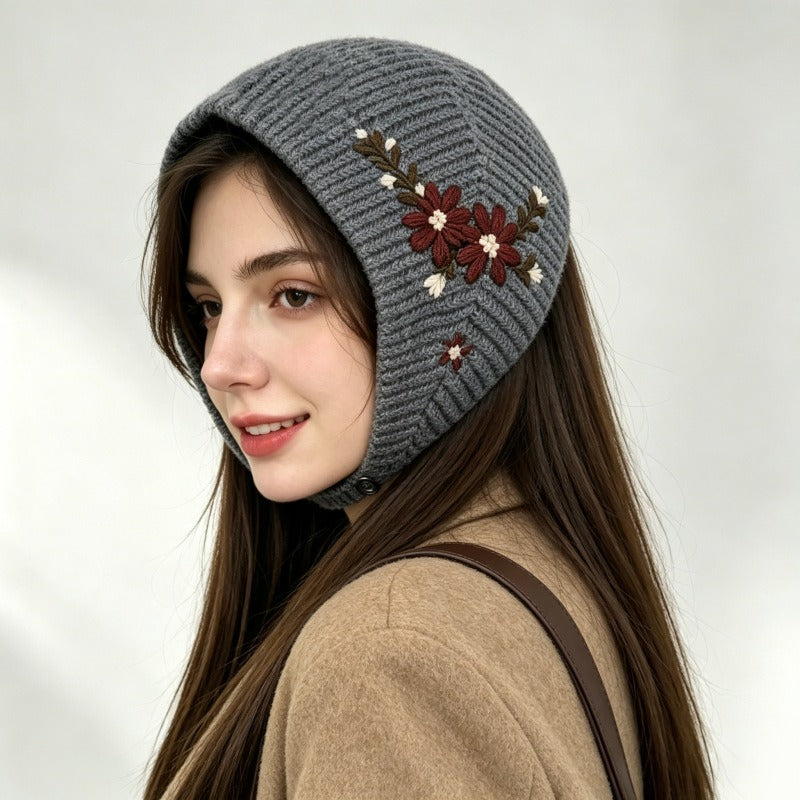 Woman wearing the grey embroidered knitted headscarf with a camel coat