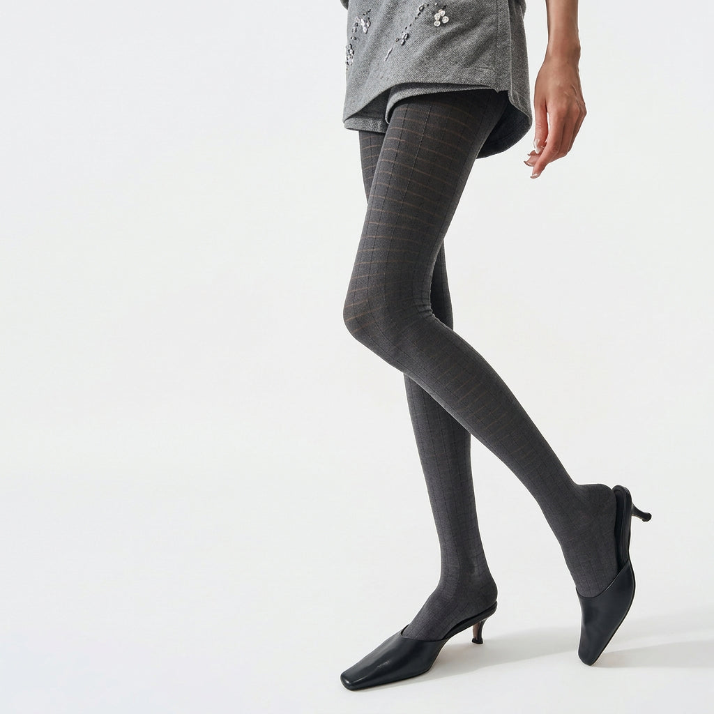 Women's 3D plaid textured tights in grey, worn with black kitten heels