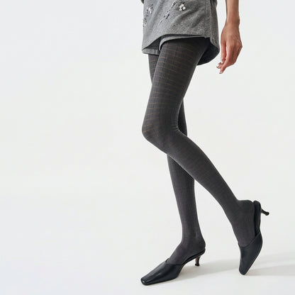 Women's 3D plaid textured tights in grey, worn with black kitten heels