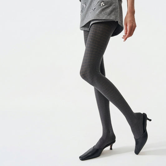 Women's 3D plaid textured tights in grey, worn with black kitten heels