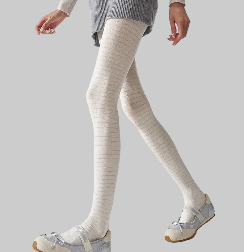 Women's 3D plaid textured tights in white, worn with silver ballet flats