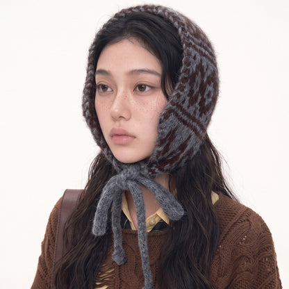 Woman wearing the grey and brown Fair Isle knitted hood with grey ties
