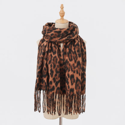 Classic brown leopard-print scarf with long fringe on a mannequin