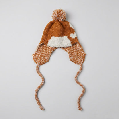 Bronze ear-flap hat with a cream heart pattern and pom-pom, laid flat