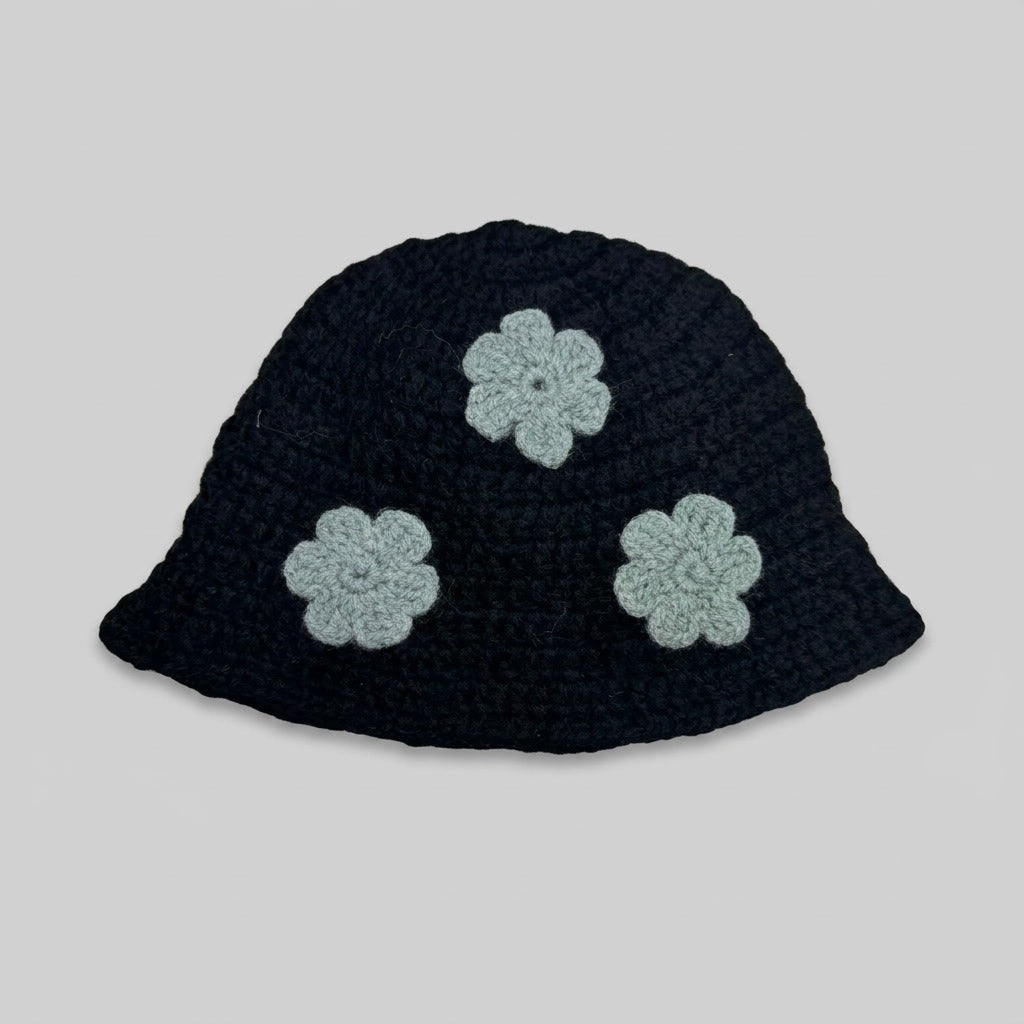 Black knitted bucket hat with three pale grey flower appliqués