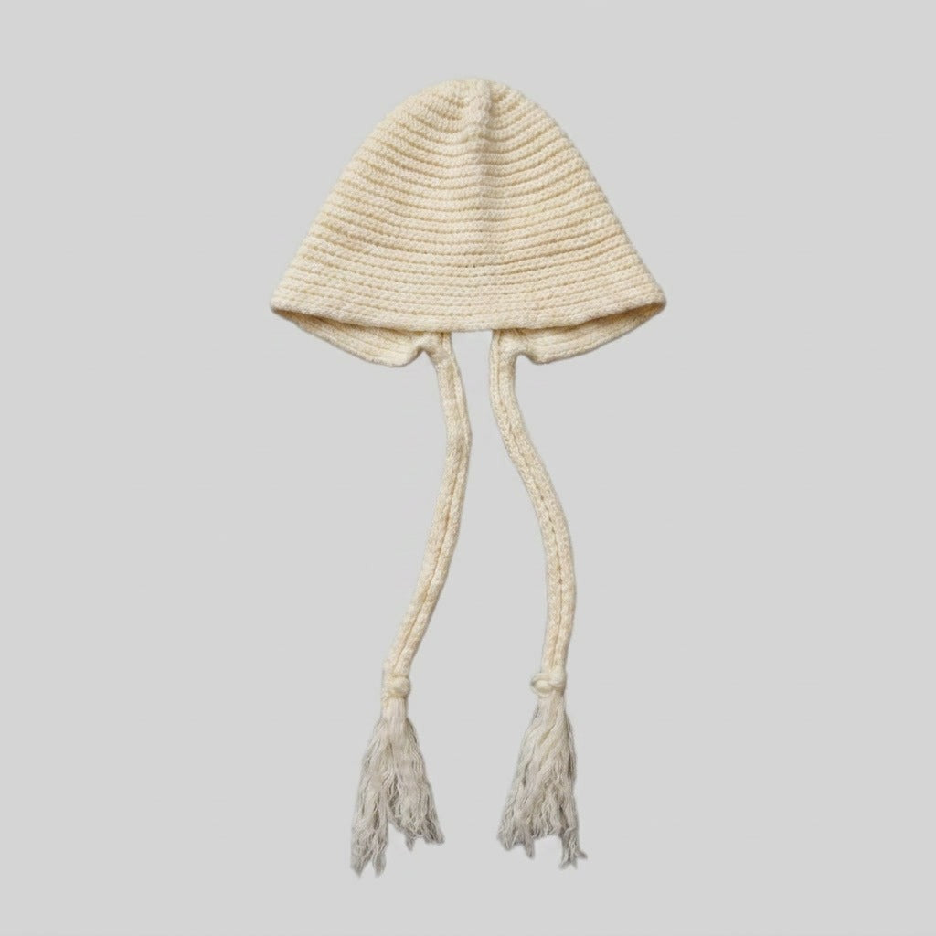 White bell-shaped knitted hat with long tasselled ties