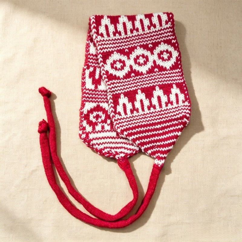 Red and white Fair Isle knitted hood laid flat with its long ties