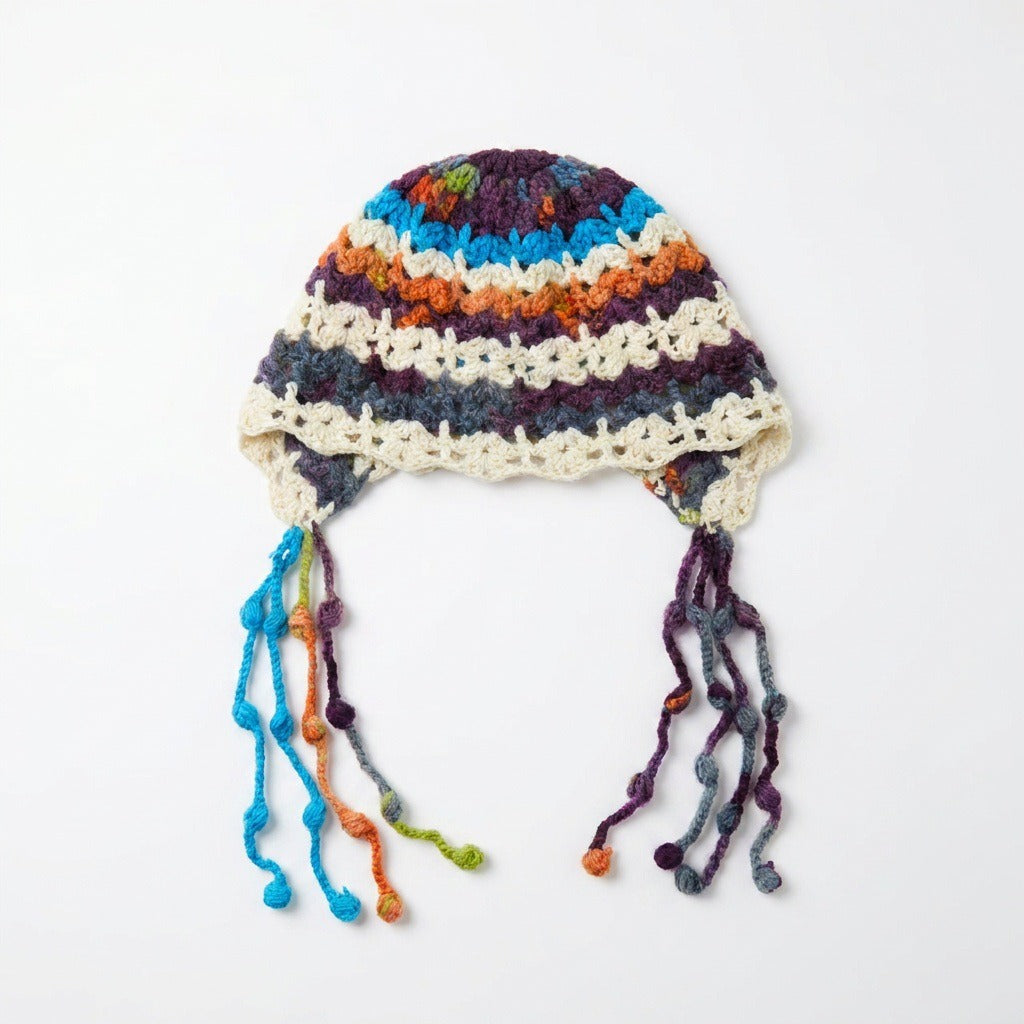 White-based multicolour striped beanie with dangling bobble strands, laid flat