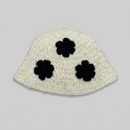 Cream knitted bucket hat with three black flower appliqués