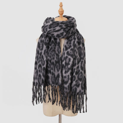Grey leopard-print scarf with long fringe on a mannequin