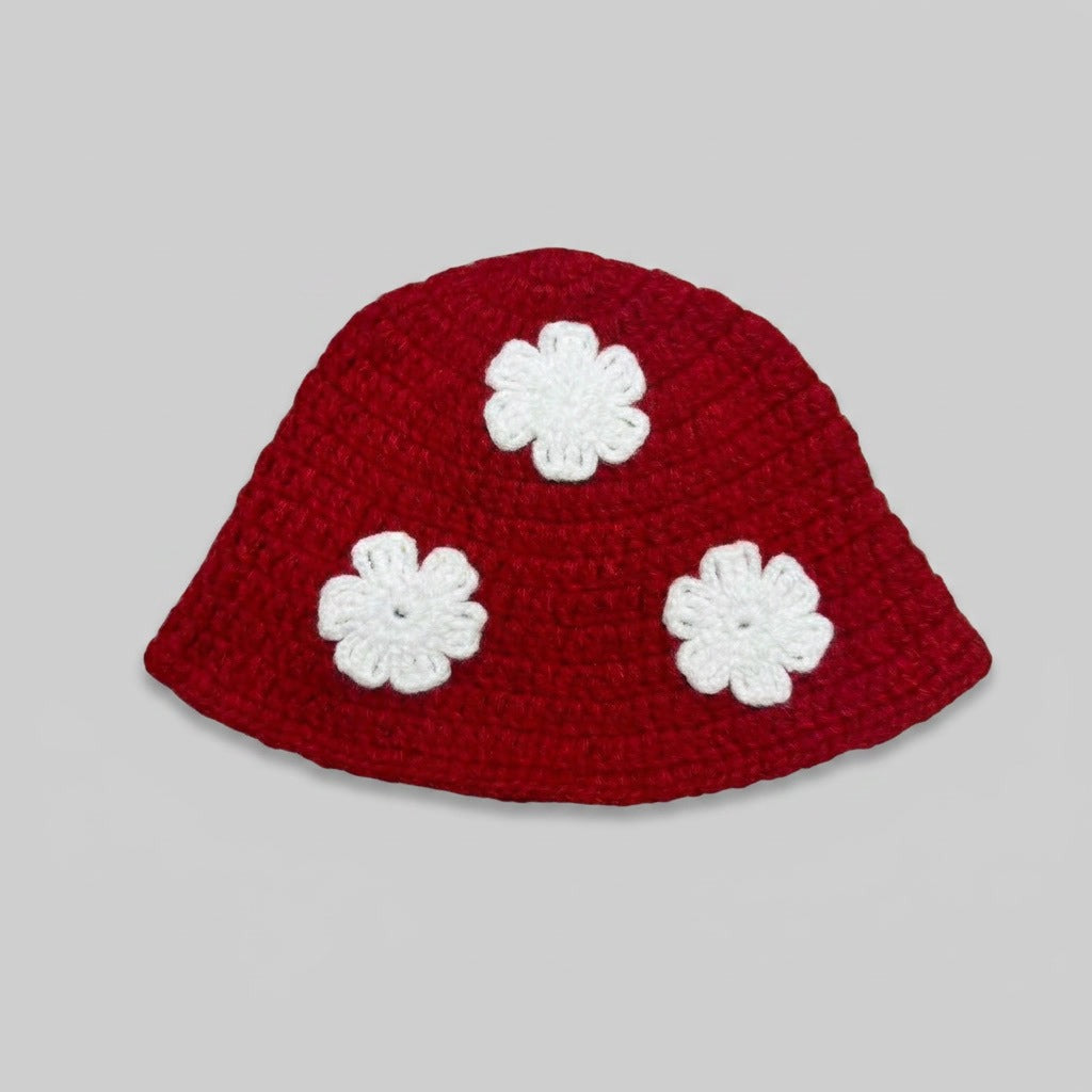 Red knitted bucket hat with three white flower appliqués
