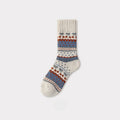 Single Nordic woolen sock with cream, blue, and rust traditional pattern.