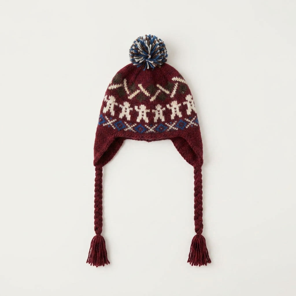 Burgundy gingerbread man ear-flap hat with navy pom-pom, laid flat