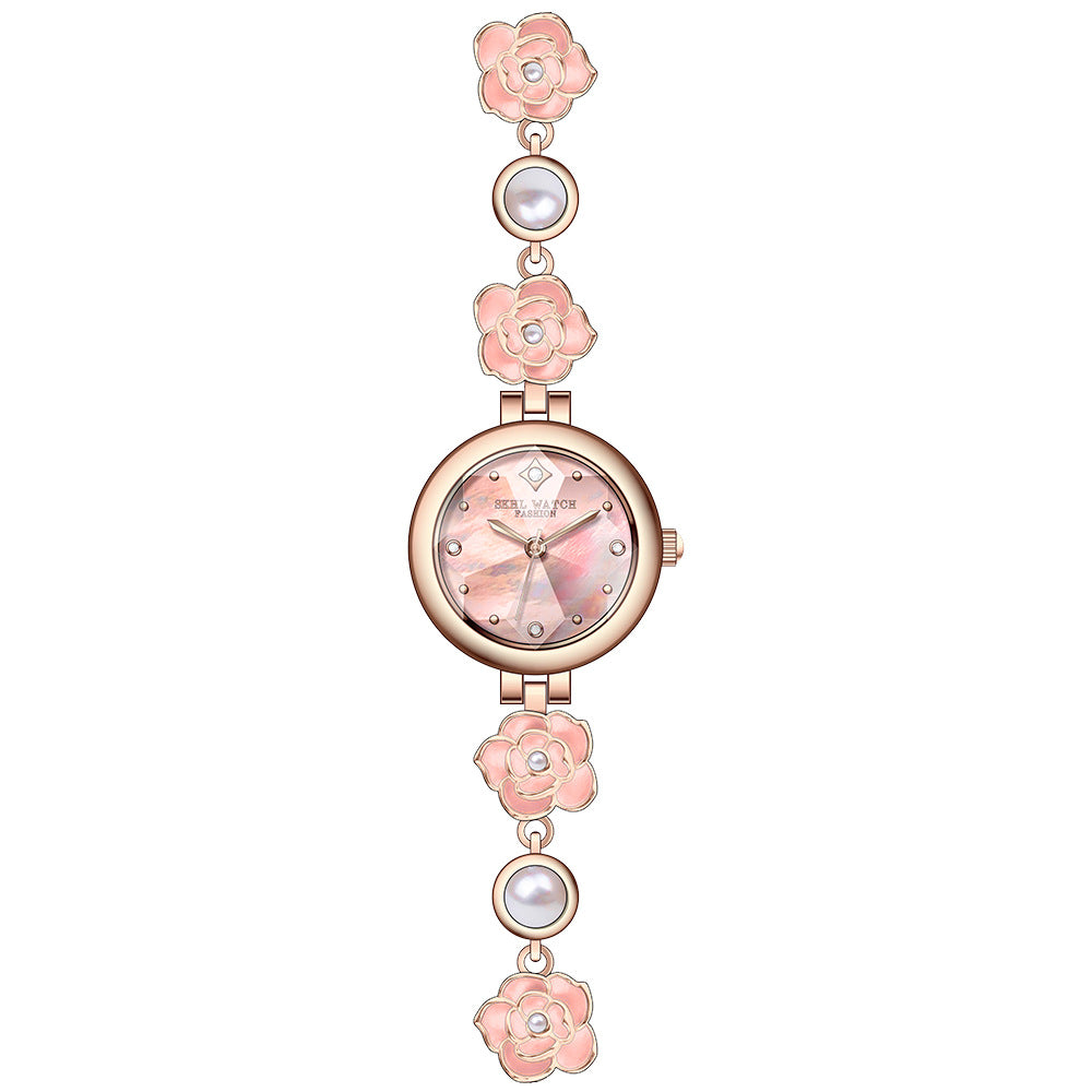 Rose gold camellia bracelet watch with pink flowers and a pink dial