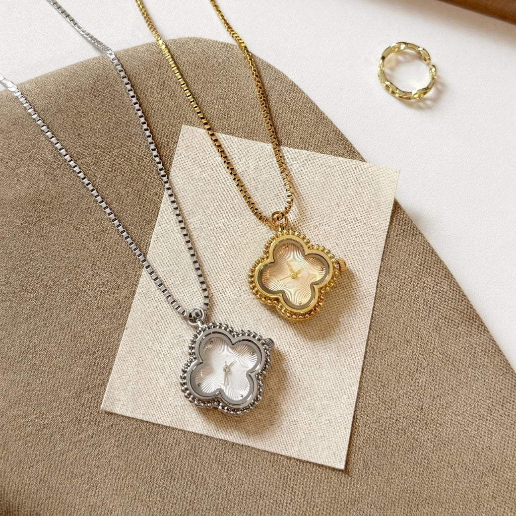 Gold and silver clover necklace watches laid side by side on a card