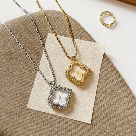 Gold and silver clover necklace watches laid side by side on a card