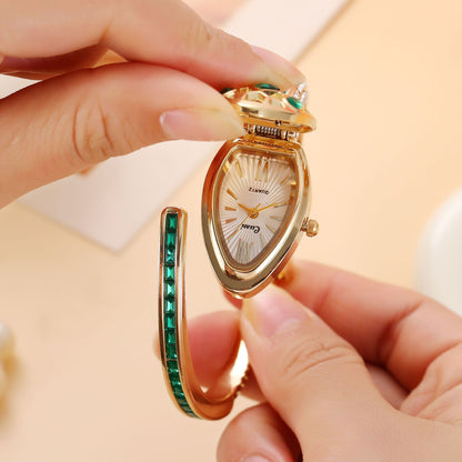 Snake head lid lifted to show a teardrop dial with Roman numerals
