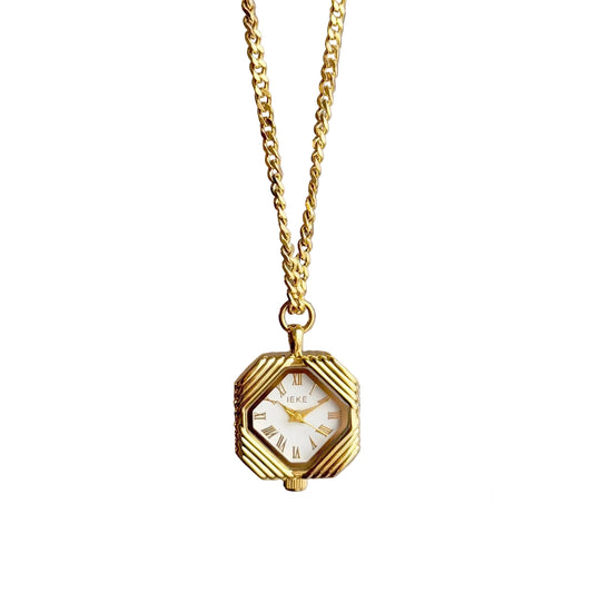 Gold octagon pendant watch with a Roman numeral dial on a curb chain
