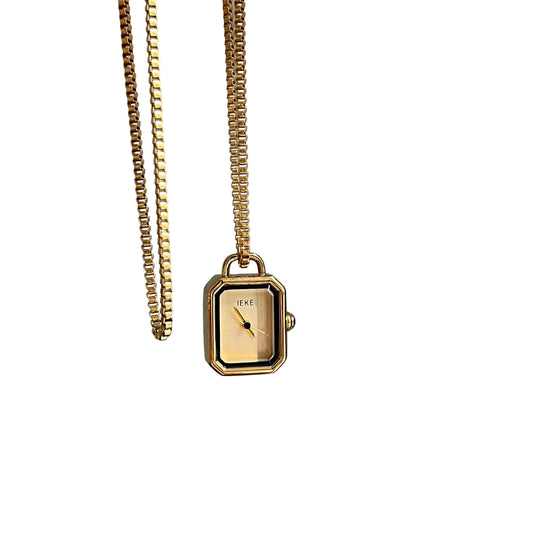 Gold rectangle pendant watch with a gold dial on a chain