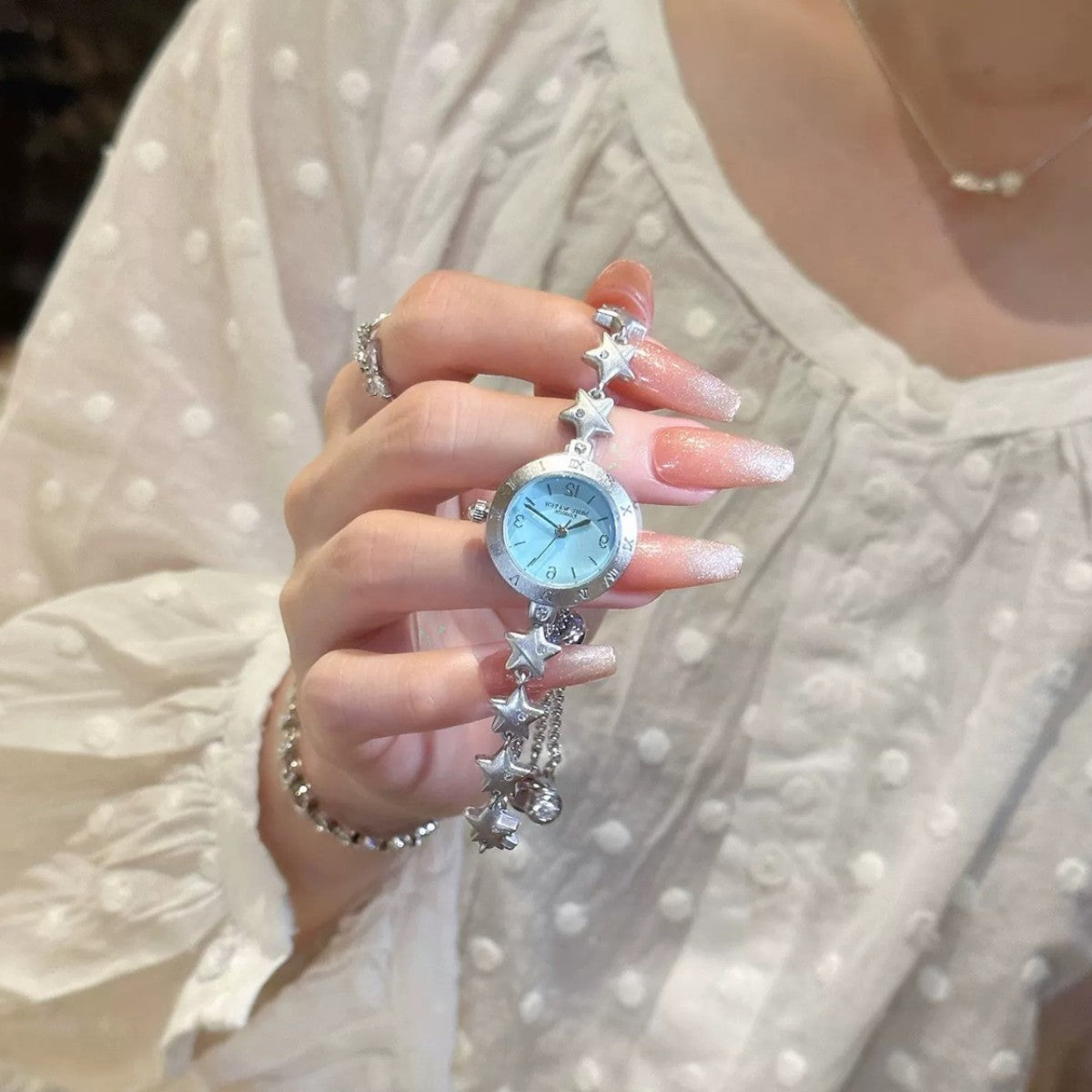 Crystal-set silver star links on a ladies bracelet watch