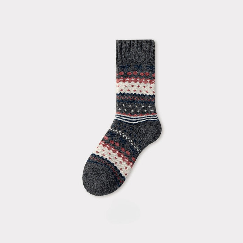 Dark gray Nordic woolen sock with red, white, and blue traditional pattern.