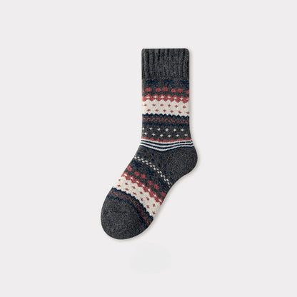 Dark gray Nordic woolen sock with red, white, and blue traditional pattern.