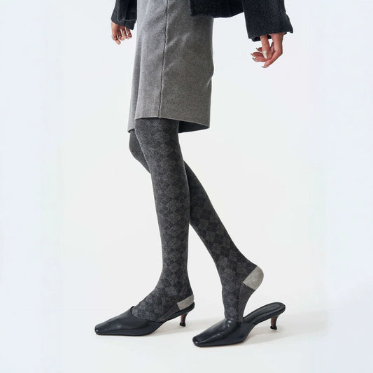 Checked wool-blend thermal tights in grey, worn with a grey skirt and black mules