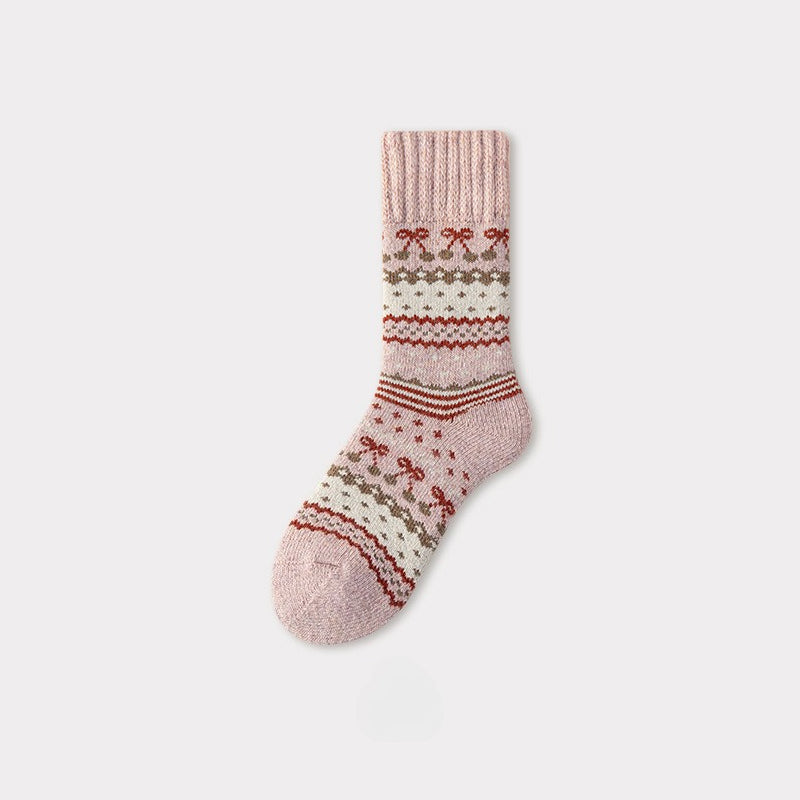 Single pink Nordic woolen sock with a traditional pattern of red bows and white stripes.