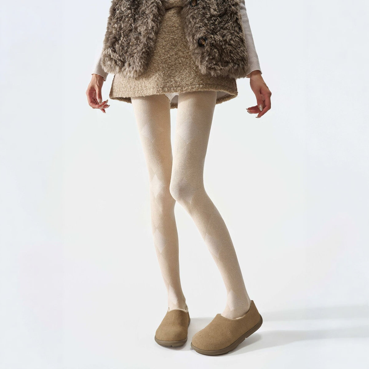 Plaid thermal tights in cream, worn with a shaggy vest and tan clogs