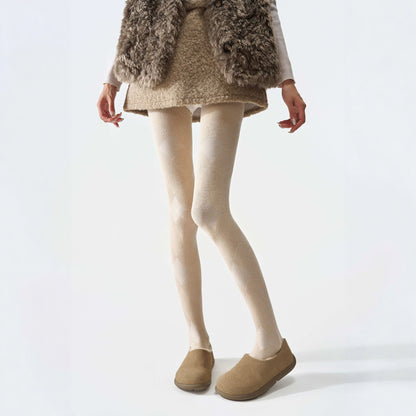 Plaid thermal tights in cream, worn with a shaggy vest and tan clogs