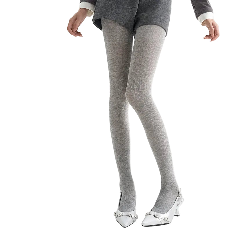 Sheer vertical-stripe tights in light grey, worn with grey shorts and white slingback heels