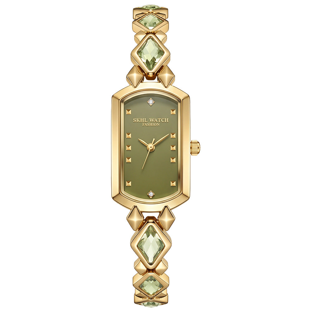 vintage women's gold-plated quartz jewelry watch featuring a barrel-shaped olive green dial and an interlocking rhombus link bracelet inlaid with faceted green crystals