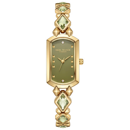 vintage women's gold-plated quartz jewelry watch featuring a barrel-shaped olive green dial and an interlocking rhombus link bracelet inlaid with faceted green crystals