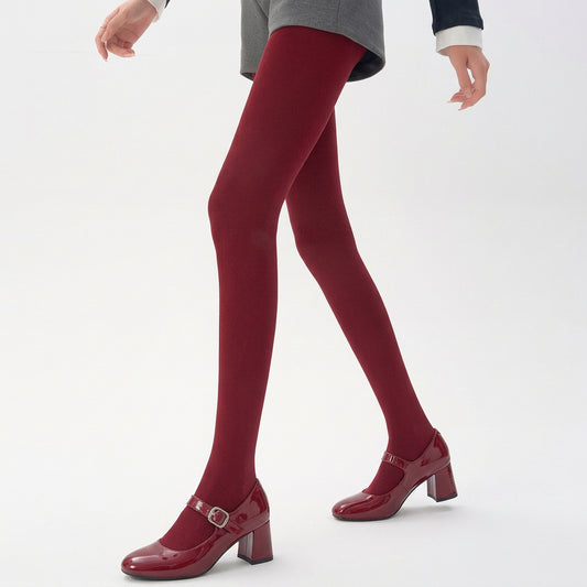 Winter thermal wool-blend tights in red, worn with red patent Mary Jane heels