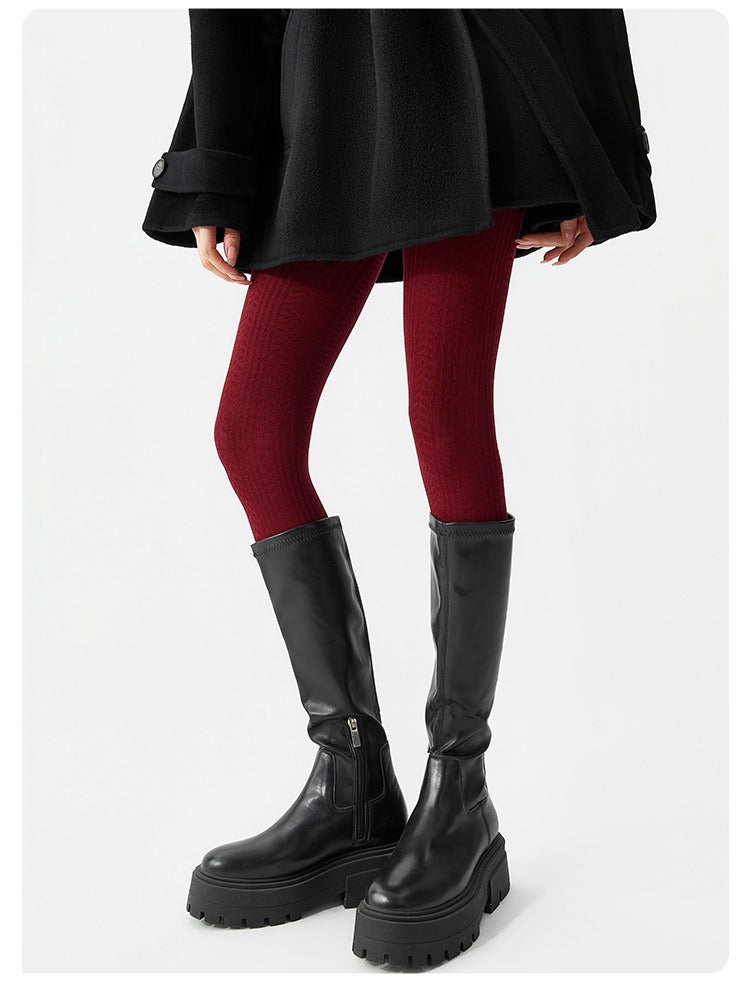 Women's knitted wool-blend winter tights in burgundy, worn with black knee-high boots