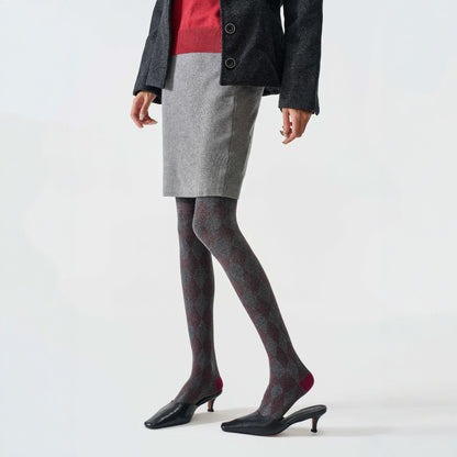 Women's tartan thermal tights in grey, worn with a grey mini skirt and black kitten heels