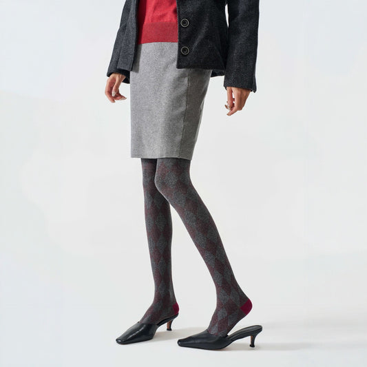 Women's tartan thermal tights in grey, worn with a grey mini skirt and black kitten heels